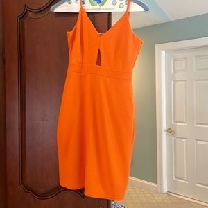 Beautiful orange mini dress with cutout. Size is medium but runs small worn 1x